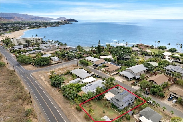 drone / aerial view featuring a water and mountain view