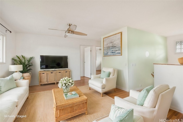 living room with ceiling fan and light hardwood / wood-style flooring