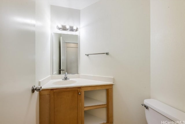 bathroom featuring toilet and vanity