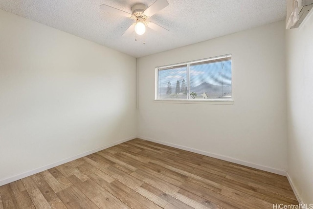 spare room featuring ceiling fan, a textured ceiling, and light hardwood / wood-style floors