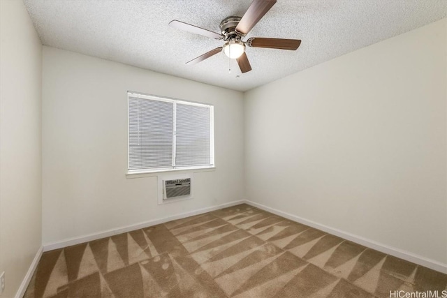 spare room with ceiling fan, a textured ceiling, a wall mounted AC, and carpet flooring