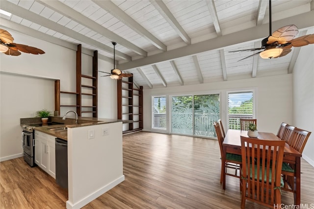 dining room featuring vaulted ceiling with beams, light hardwood / wood-style flooring, sink, and wooden ceiling