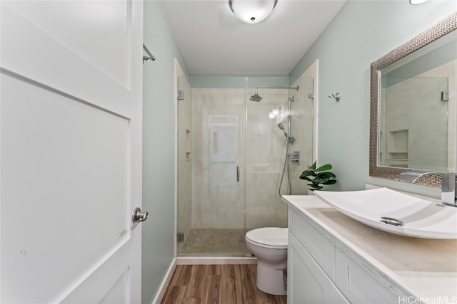 bathroom with vanity, hardwood / wood-style floors, toilet, and walk in shower