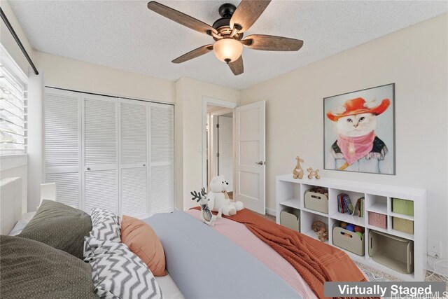 bedroom featuring a closet, ceiling fan, and a textured ceiling