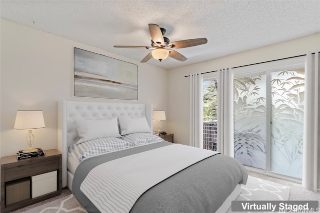 carpeted bedroom featuring a textured ceiling and ceiling fan