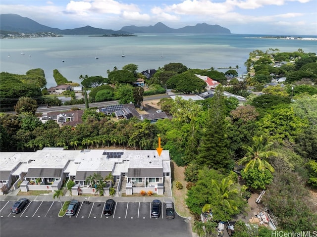 birds eye view of property with a water and mountain view