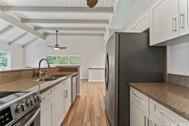 kitchen with white cabinets, appliances with stainless steel finishes, light wood-type flooring, lofted ceiling with beams, and sink