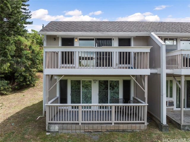 back of property with a balcony