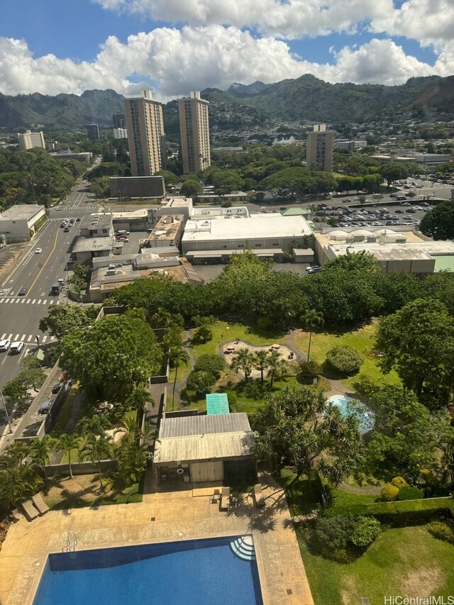 1255 Nuuanu Ave Unit E1414, Honolulu, HI 96817 - aerial overview of property's location featuring a mountainous background, a pool, and nearby urban area