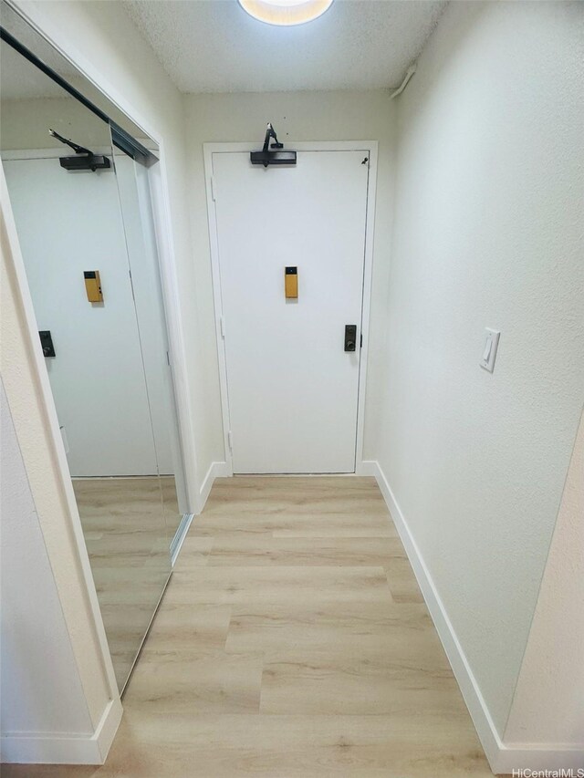1255 Nuuanu Ave Unit E1414, Honolulu, HI 96817 - hallway with light wood-style floors and baseboards