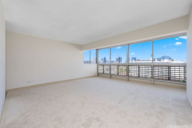 carpeted spare room with a textured ceiling