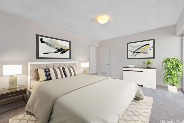 bedroom featuring a textured ceiling and carpet flooring