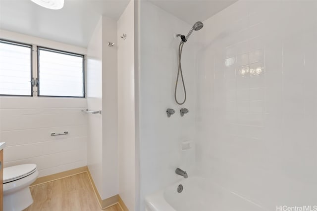 full bathroom featuring vanity, toilet, hardwood / wood-style flooring, and tiled shower / bath combo