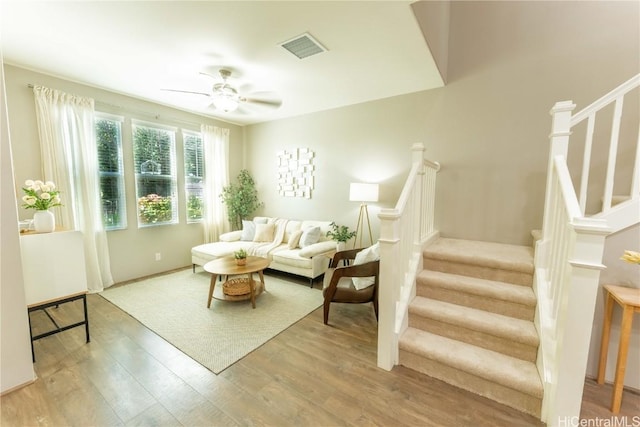 living room with wood-type flooring and ceiling fan