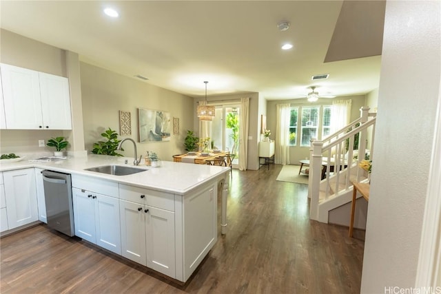 kitchen featuring kitchen peninsula, white cabinetry, sink, and stainless steel dishwasher