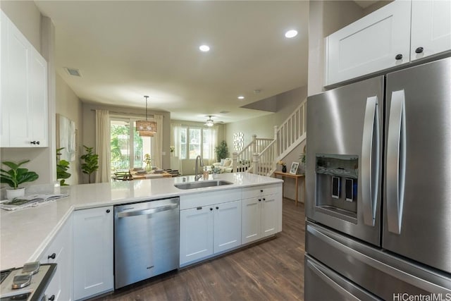 kitchen featuring white cabinetry, sink, dark hardwood / wood-style floors, and appliances with stainless steel finishes