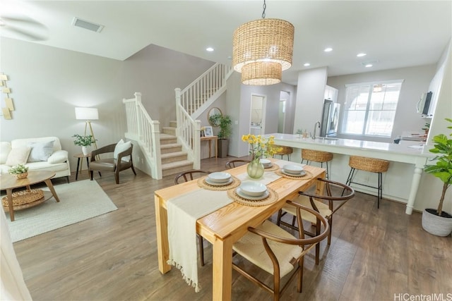 dining space with a chandelier and hardwood / wood-style flooring