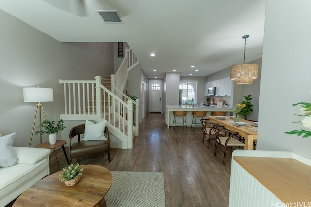 living room with dark hardwood / wood-style flooring