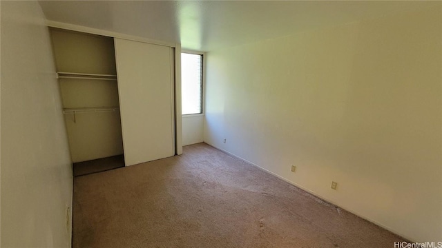 unfurnished bedroom featuring a closet and carpet