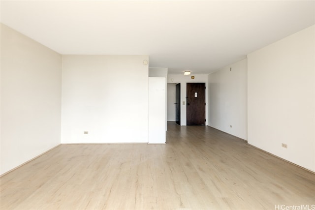 spare room featuring light hardwood / wood-style floors