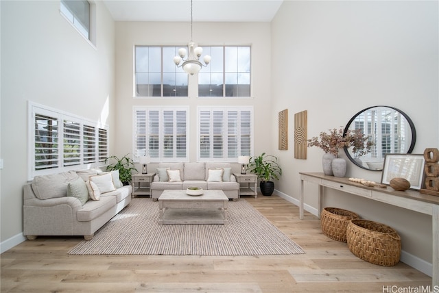 sunroom featuring an inviting chandelier and plenty of natural light