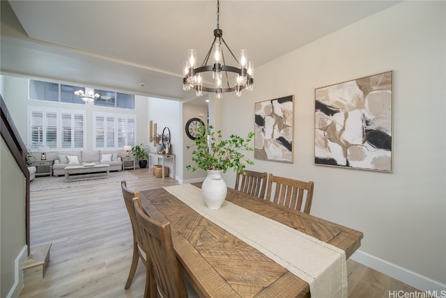 dining area featuring a chandelier and light wood-type flooring