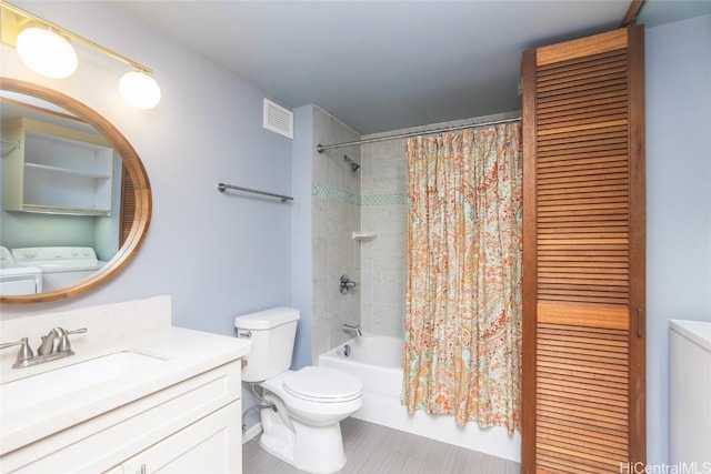 full bathroom featuring vanity, shower / bath combo, washing machine and clothes dryer, and toilet