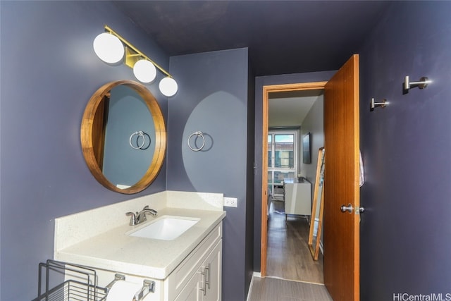 bathroom with vanity and wood-type flooring