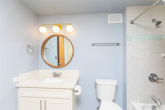 full bathroom featuring vanity, toilet, and tiled shower / bath combo