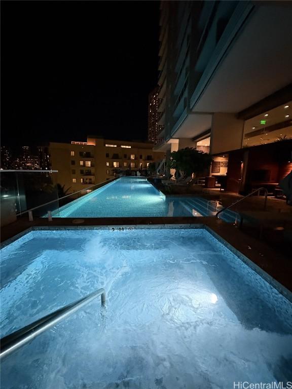 view of pool at night