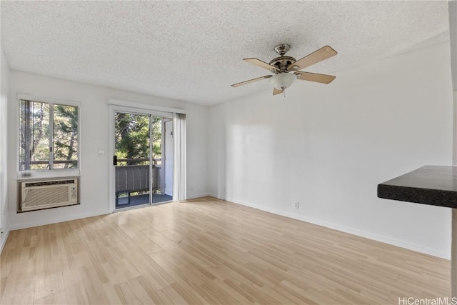 unfurnished living room featuring a textured ceiling, light hardwood / wood-style floors, and ceiling fan