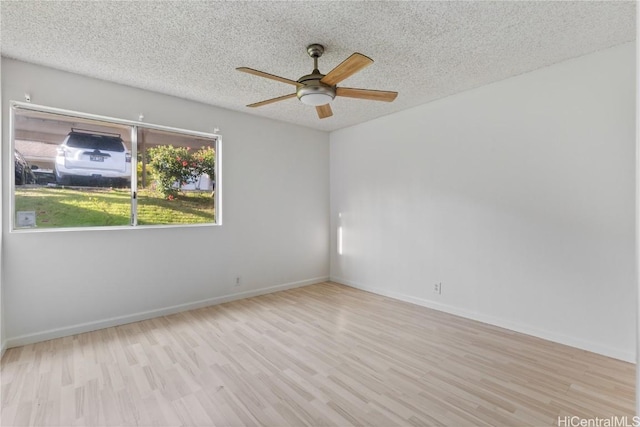 empty room with ceiling fan, light hardwood / wood-style flooring, and a textured ceiling