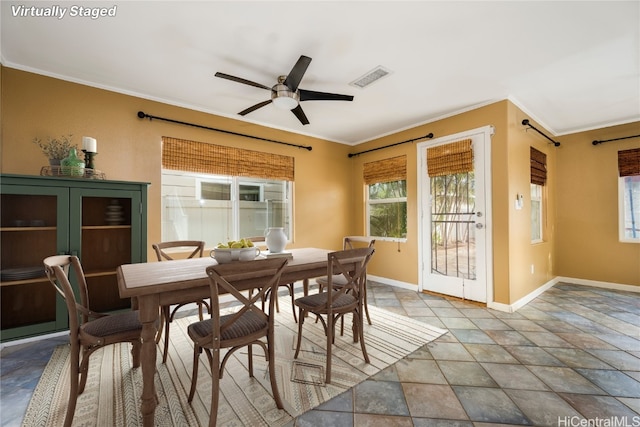 dining room with crown molding and ceiling fan