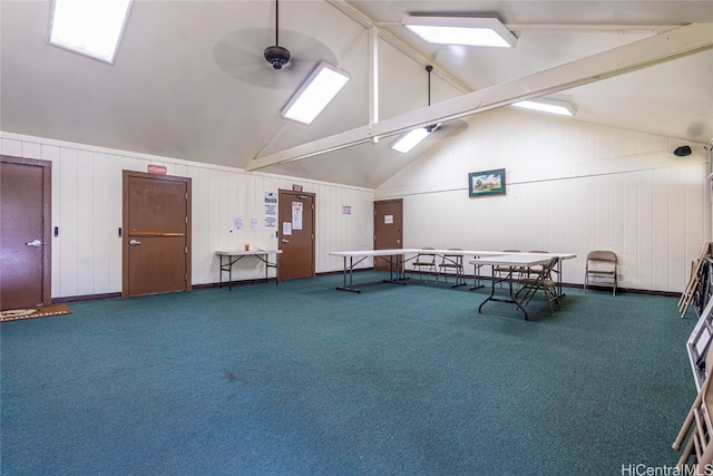 miscellaneous room featuring ceiling fan, high vaulted ceiling, carpet floors, beamed ceiling, and wooden walls