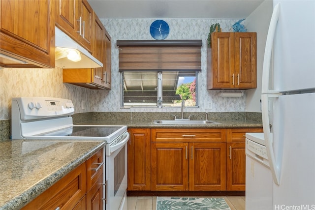 kitchen featuring white appliances, light tile patterned floors, and sink