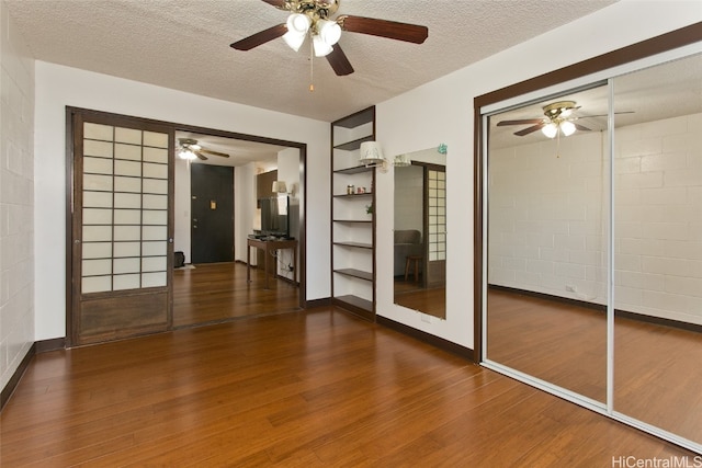 empty room featuring dark wood-type flooring and a textured ceiling