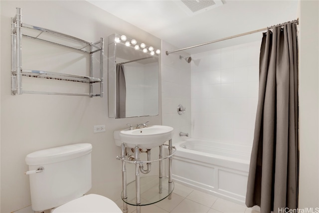 full bathroom with toilet, sink, tile patterned floors, and shower / tub combo