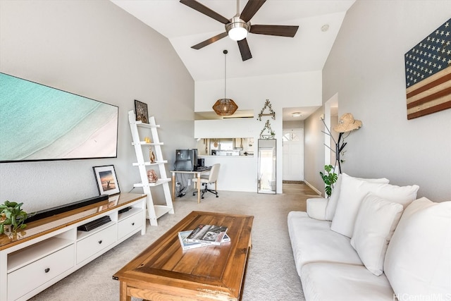 carpeted living room featuring ceiling fan and high vaulted ceiling