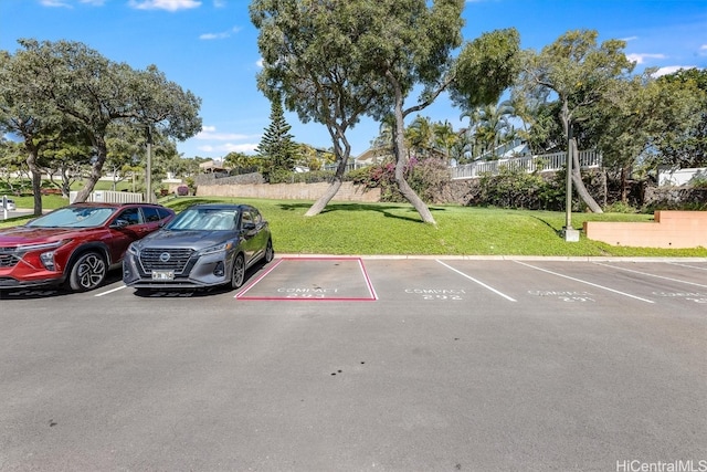 view of car parking featuring a lawn