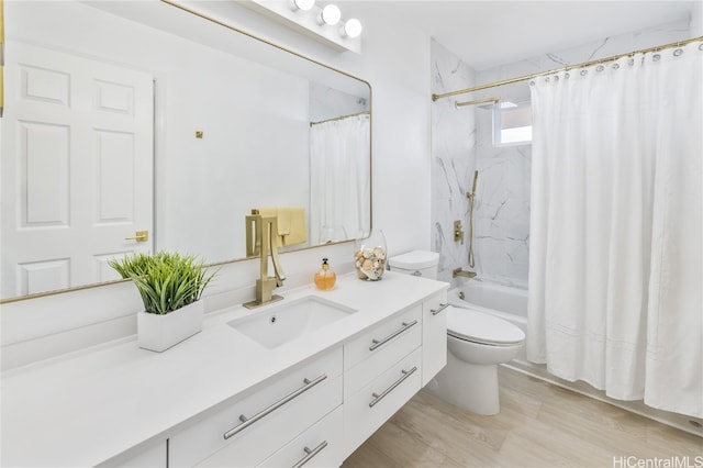 full bathroom with hardwood / wood-style floors, vanity, shower / bath combo, and toilet