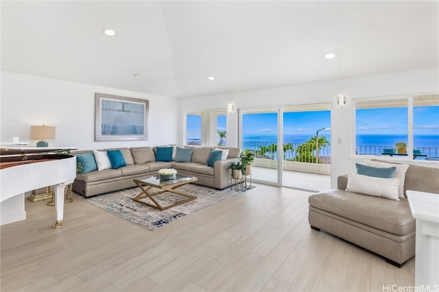 living room featuring a water view and light wood-type flooring