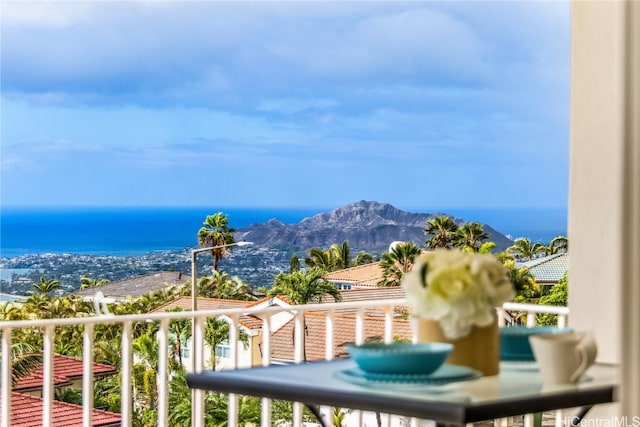 balcony featuring a water and mountain view