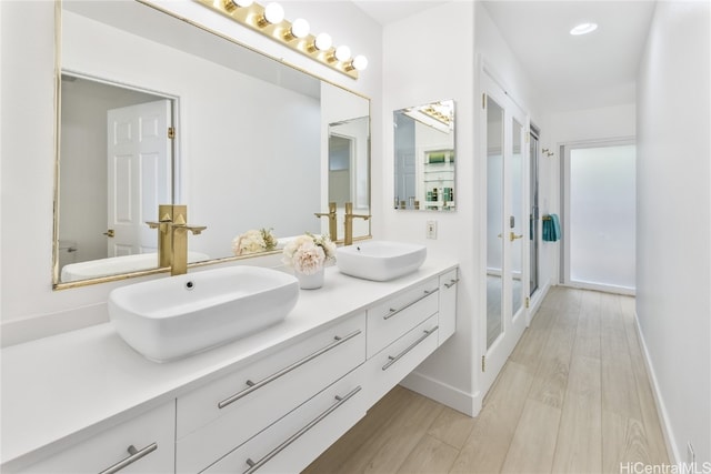 bathroom featuring hardwood / wood-style flooring and vanity