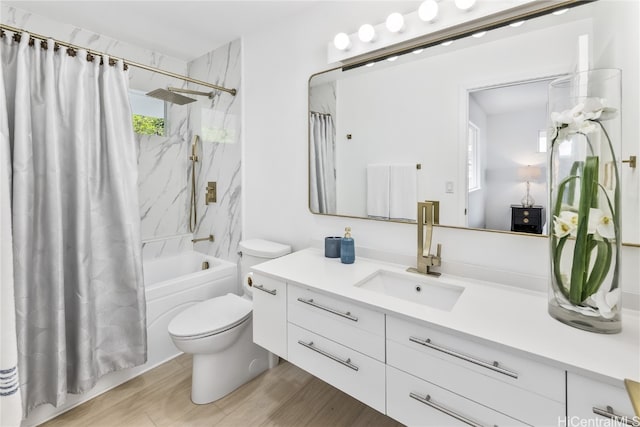 full bathroom featuring vanity, wood-type flooring, shower / bath combo, and toilet