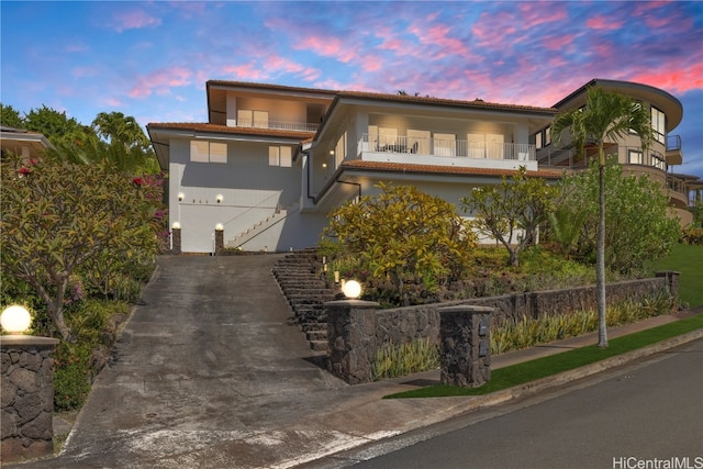 view of front of house featuring a balcony