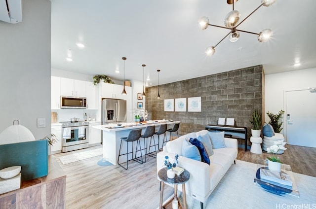 living room with light hardwood / wood-style floors, a wall mounted AC, and tile walls