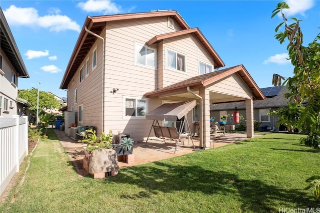 back of house with cooling unit, a yard, and a patio area