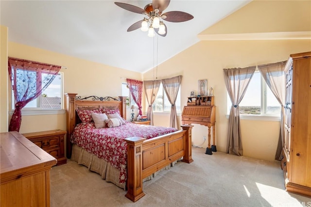 bedroom with multiple windows, vaulted ceiling, light colored carpet, and ceiling fan