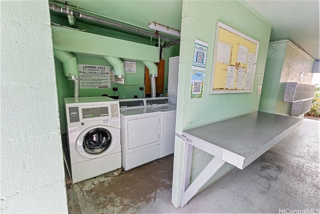 clothes washing area featuring separate washer and dryer