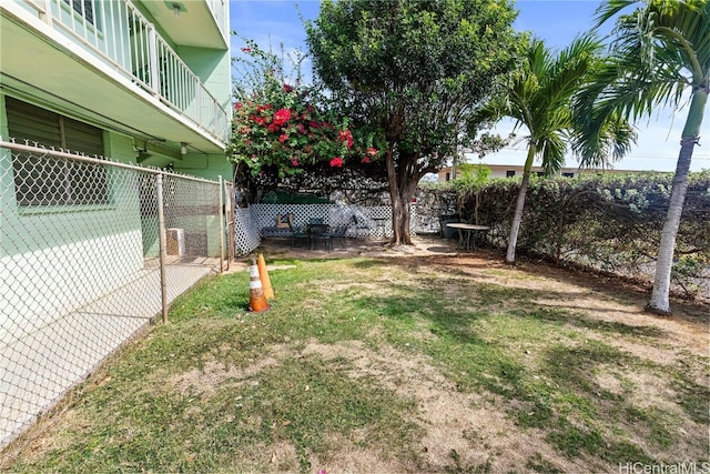 view of yard with a balcony